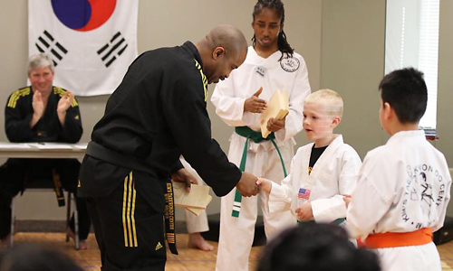 Head Master Instructor Will Brown Shaking Hands with a Boy